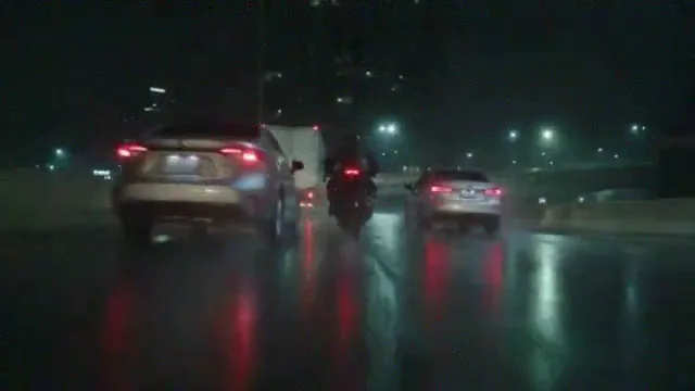 A night motorcycle take on a wet expressway at 360p: soft, grainy and blocky, the rider and the cars smeared