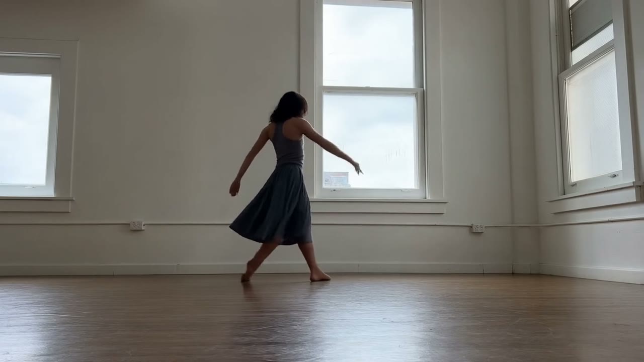 Example made with Hailuo 2.3: A dancer drops into a low spin on a scuffed studio floor, skirt flaring and settling with believable weight, hair following a beat late. Hard side…