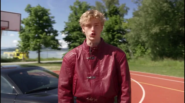 Orbit: the camera travels round him while he talks, the court, the trees and the lake turning behind him, the car coming back into view