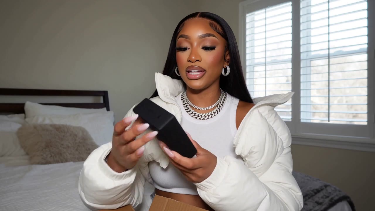 Selfie style UGC unboxing: a creator presents a branded gift box to camera