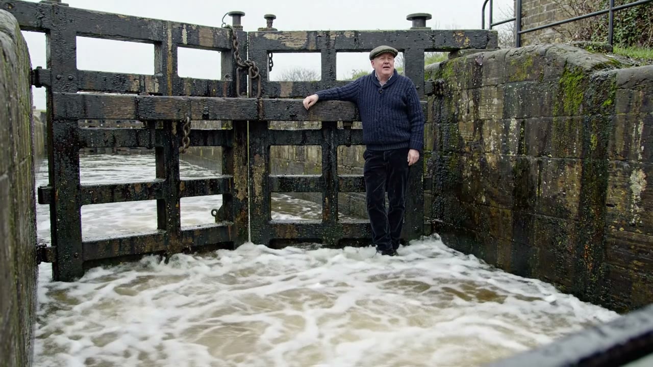 Example made with Veo 3.1 Lite: A canal lock keeper leans on the beam watching water boil into the chamber and says, "Take your time." Rushing water and creaking timber under the…